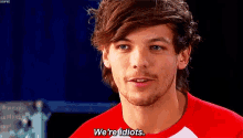 a man in a red shirt is saying we 're idiots