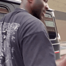 a man wearing a black t-shirt with a picture on the back of it