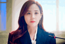 a woman with red hair is wearing a suit and tie