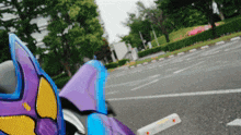 a purple and blue motorcycle is parked on the side of a road