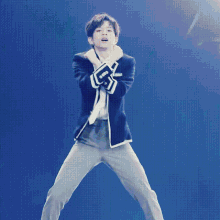 a man in a suit is dancing on a stage