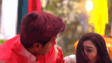 a man and a woman are looking at each other
