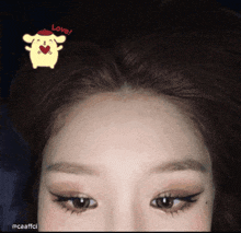 a close up of a woman 's forehead with a sticker that says love