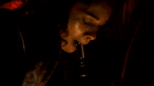 a person in a dark room with a red light shining on them