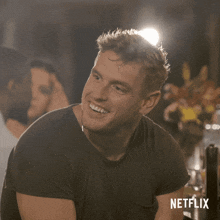 a man is making a funny face with a netflix logo in the background