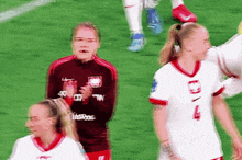 a soccer player wearing a number 4 jersey applauds her teammates