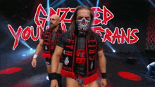 two wrestlers are walking on a stage in front of a sign that says " grizzly ed frans "