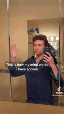 a man taking a selfie in front of a mirror with a caption that says this is how my mind works