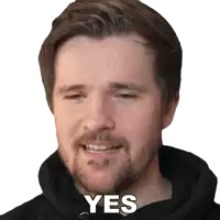 a man with a beard wearing a black hoodie says " yes "