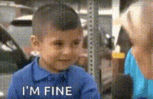 a little boy in a blue shirt says " i 'm fine "