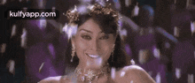 a woman is wearing a crown of flowers and a necklace .