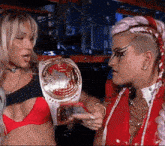 a woman wearing a world heavyweight wrestling belt