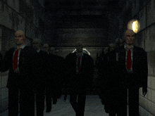 a group of bald men in suits and ties are standing in a line