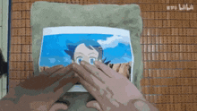 a person is holding a picture of a girl with blue eyes .