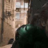 a man in a green jacket is walking down a street .