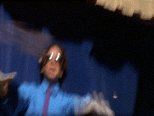 a blurry picture of a person wearing a blue shirt and tie