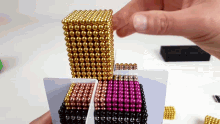 a person is playing with a stack of magnetic balls