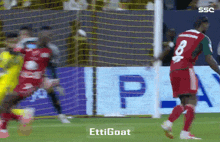 a soccer player with the number 8 on his jersey is running towards the goal