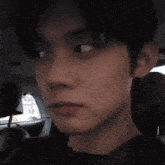 a close up of a person 's face in a car seat