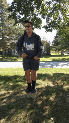 a boy wearing a sweatshirt that says maximo