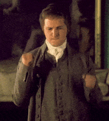 a man in a suit is standing in front of a mirror