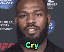 a man with a beard says " cry " in front of a bud light sign