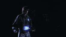 a person in a blue jacket with the word adidas on the front