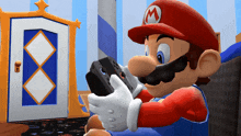 mario is playing a video game while wearing a red hat with the letter m on it