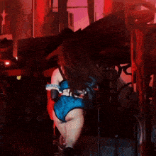 a woman in a wonder woman costume is playing a guitar on a stage