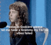 a woman speaking into a microphone with a caption that says please st godcent