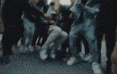 a blurry picture of a group of people fighting in a room