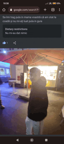 a man standing under an umbrella on a google search