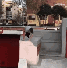 a man is doing a trick in front of a building that says awesome on it