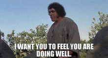 a man is standing in a field with trees in the background and says `` i want you to feel you are doing well '' .