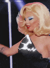 a woman with blonde hair and blue eye shadow is on a tumblr page