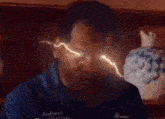 a man with lightning coming out of his eyes is wearing an animal shirt