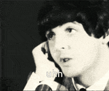 a black and white photo of a man with uhh written on the bottom right