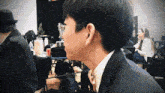 a man wearing glasses and a suit looks down