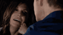 a man and a woman are looking at each other in a car