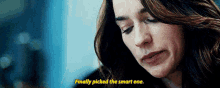 a close up of a woman 's face with the words finally picked the smart one below her