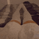 a person laying on a bed with their legs crossed