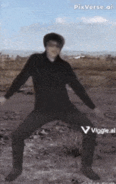 a man in a black shirt is dancing in the desert