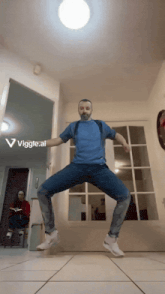 a man in a blue shirt is dancing in a hallway with a woman sitting in the background and the words viggle.ai below him