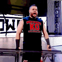a wrestler wearing a black shirt that says ko