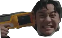a man in a suit is holding a yellow toy gun with a warning on the side