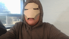 a man with a cardboard mask on his face