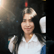 a woman with long dark hair is smiling for the camera