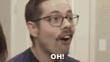 a man wearing glasses and a mustache is making a funny face and saying `` oh '' .