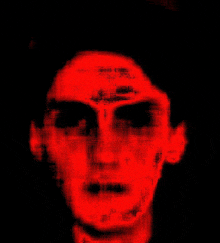 a blurry picture of a man 's face with a red background