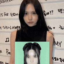 a woman is standing in front of a wall that says my